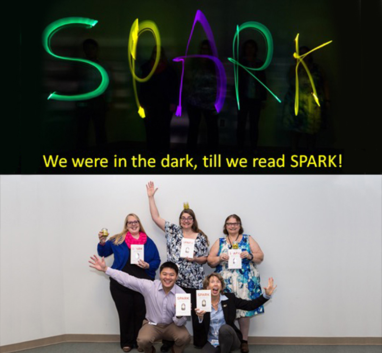 an image with a group of readers holding the SPARK book, and words that say "SPARK: We were in the dark till we read SPARK!"