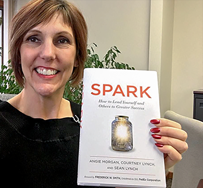woman holding the SPARK book