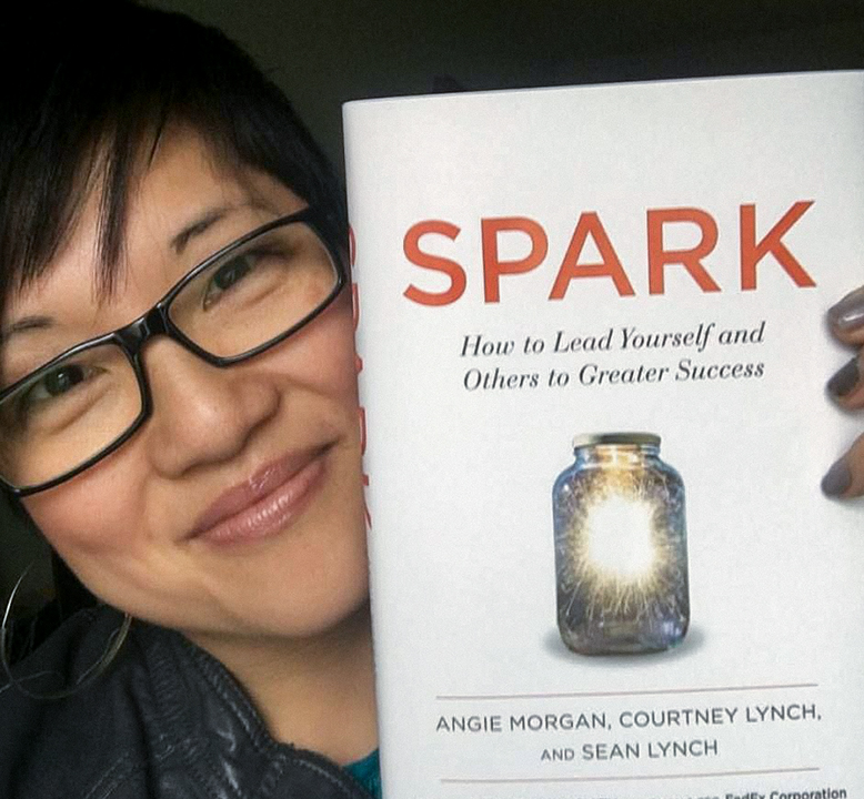a woman holding the SPARK book